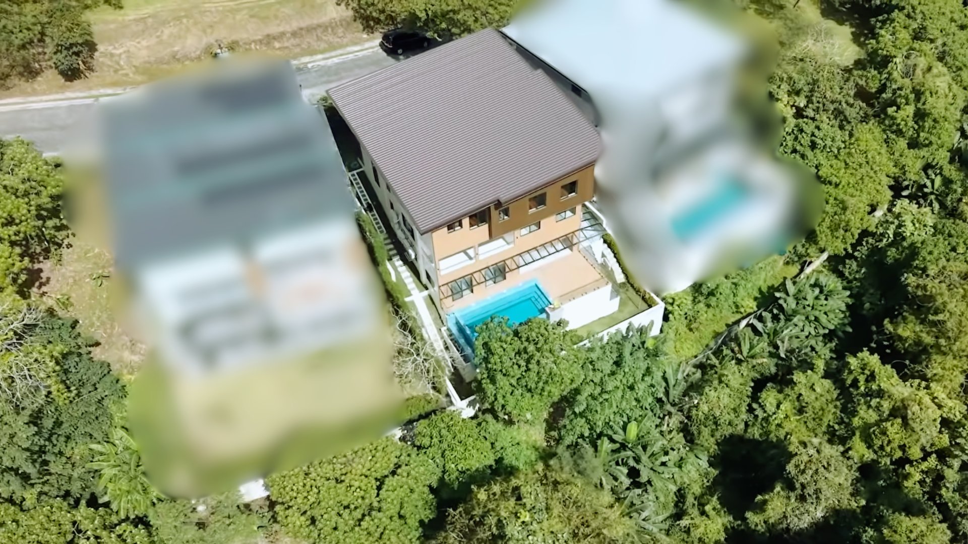 Aerial drone view showing the property surrounded by forest