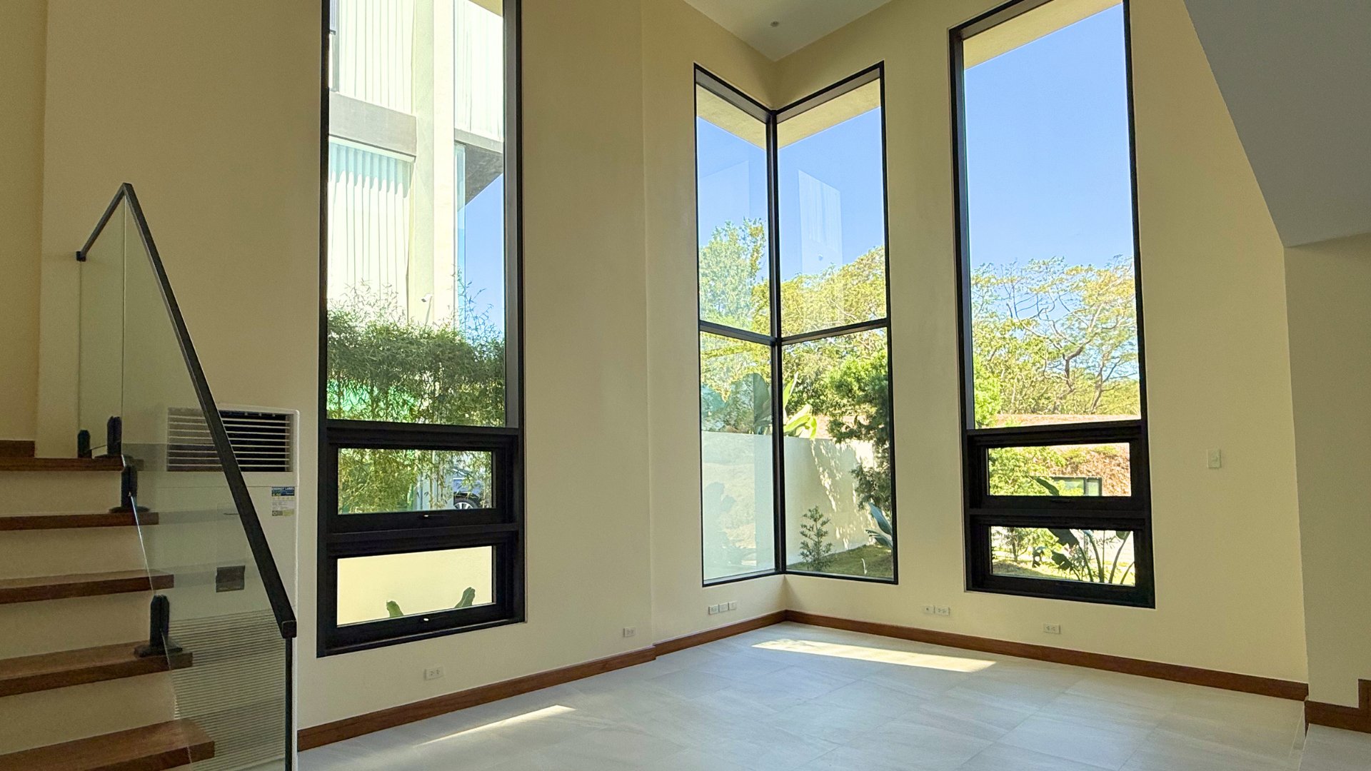 Double-height foyer with floor-to-ceiling windows