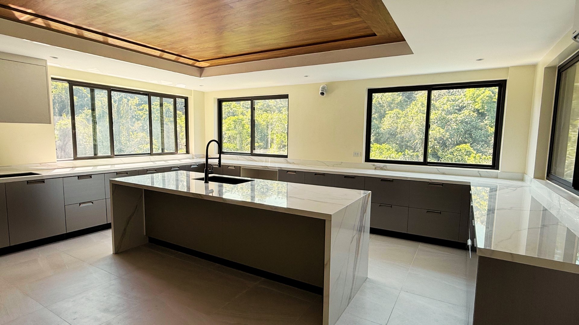 Gourmet kitchen with marble island and wood ceiling