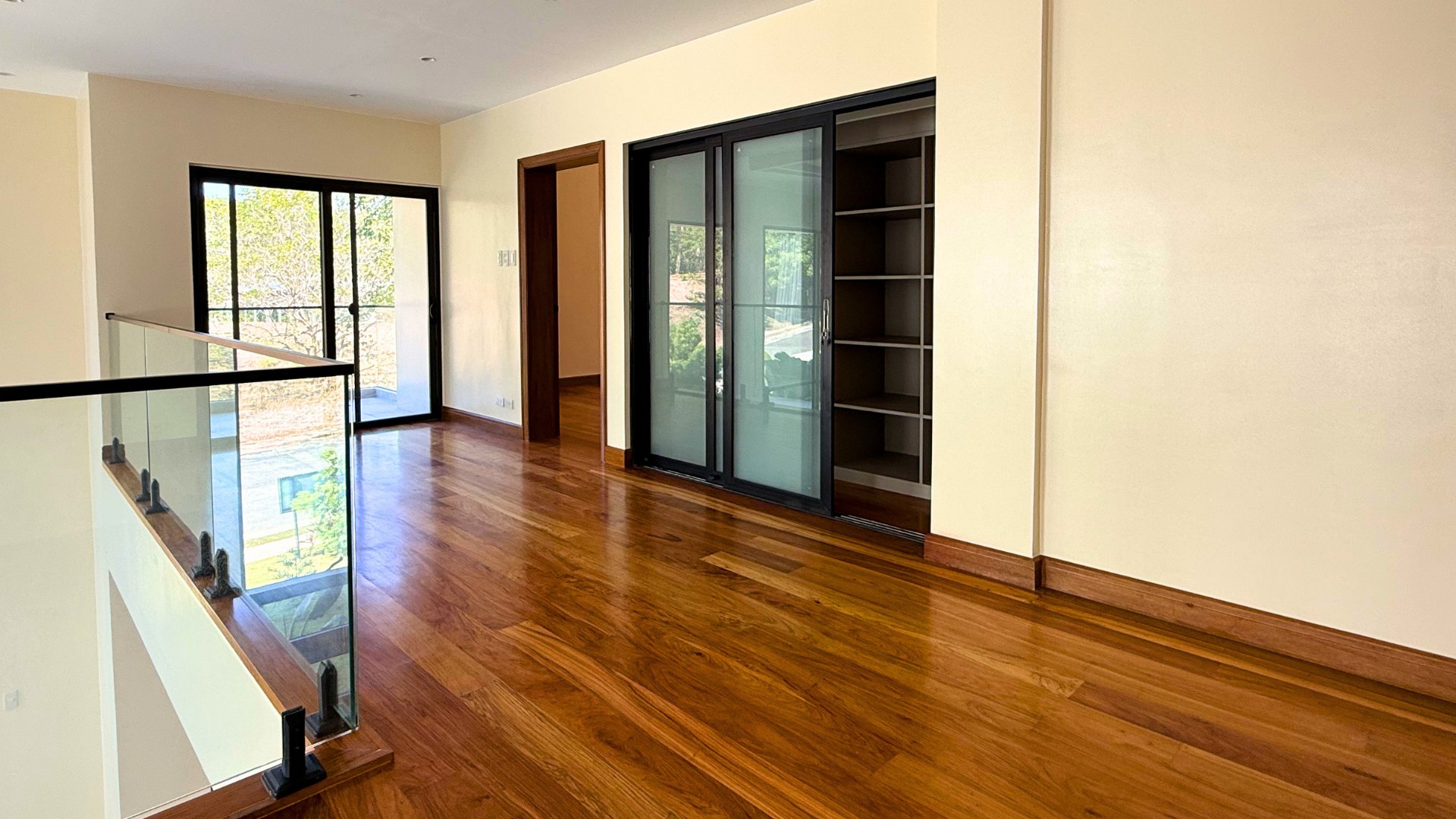 Upper hallway with hardwood floors and built-in closet